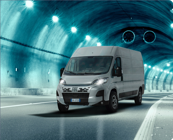 A white van driving through a tunnel