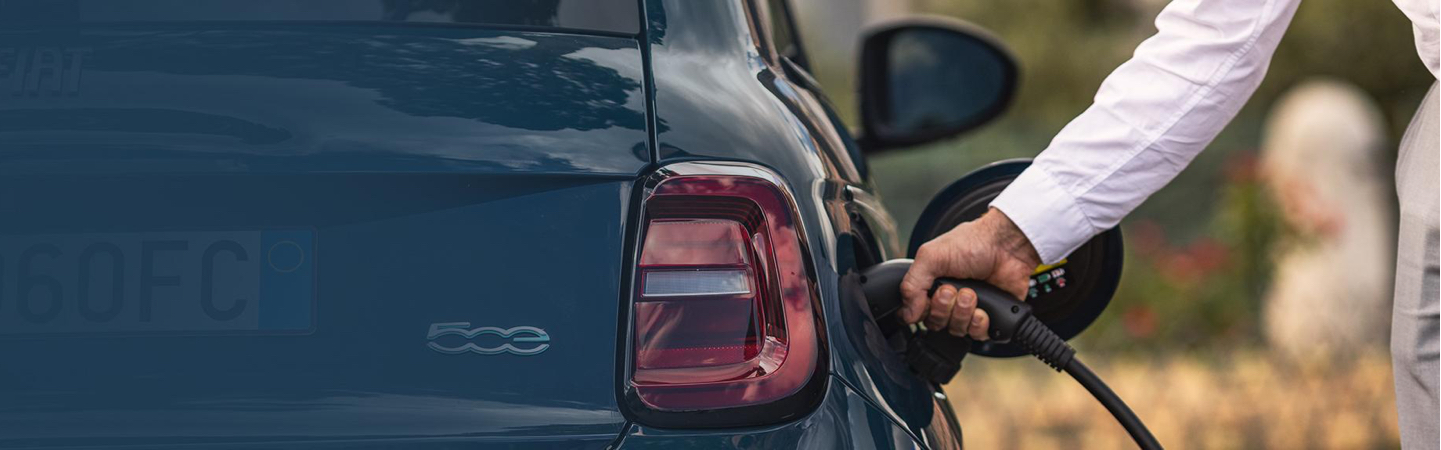 A person fuelling a car.