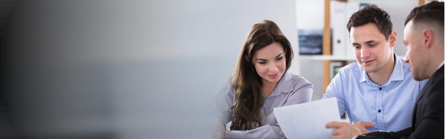 Three business people reviewing a document