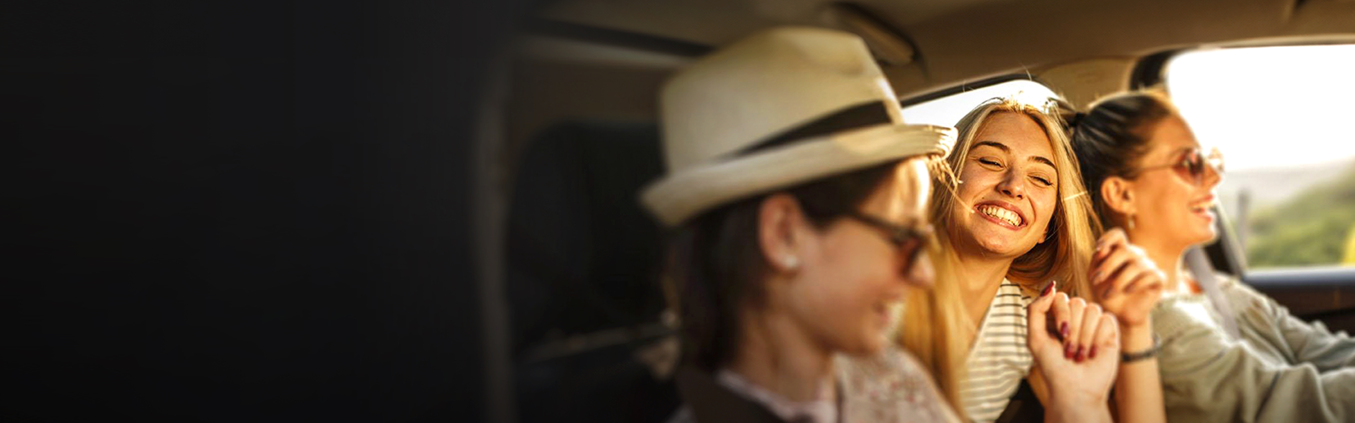 Three friends singing in a car