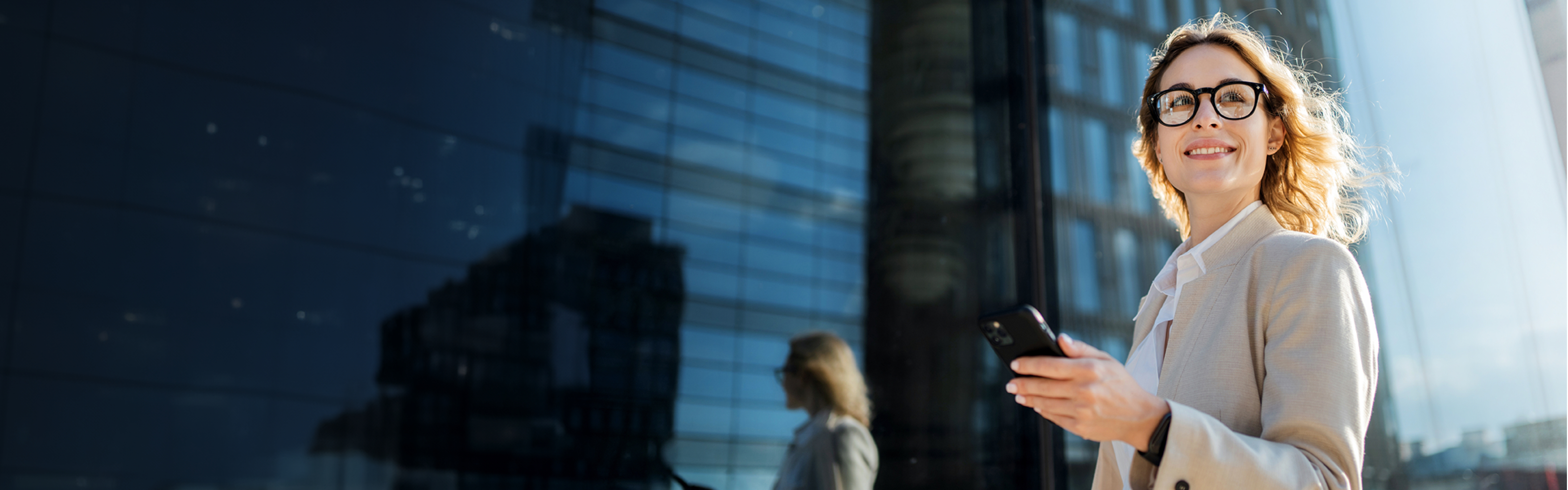 A woman standing outside of a office bloc.