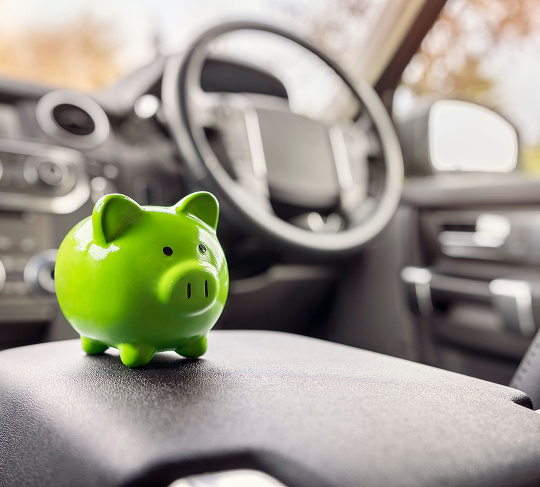 A lime green piggy bank sitting in a car