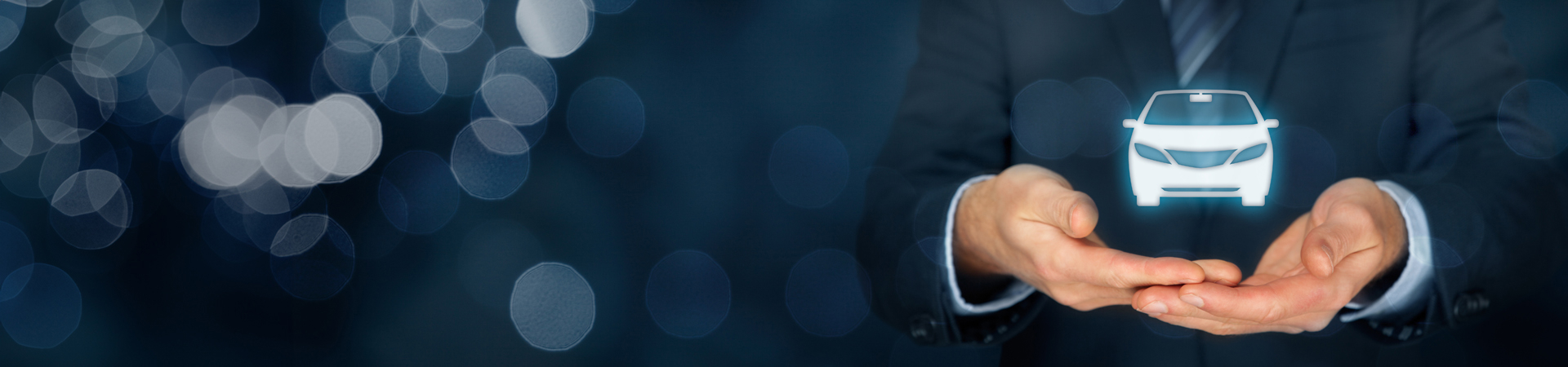 A man in a suit cradling an icon representing a car.