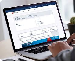A person working on a laptop showing the My Leasys app on it.